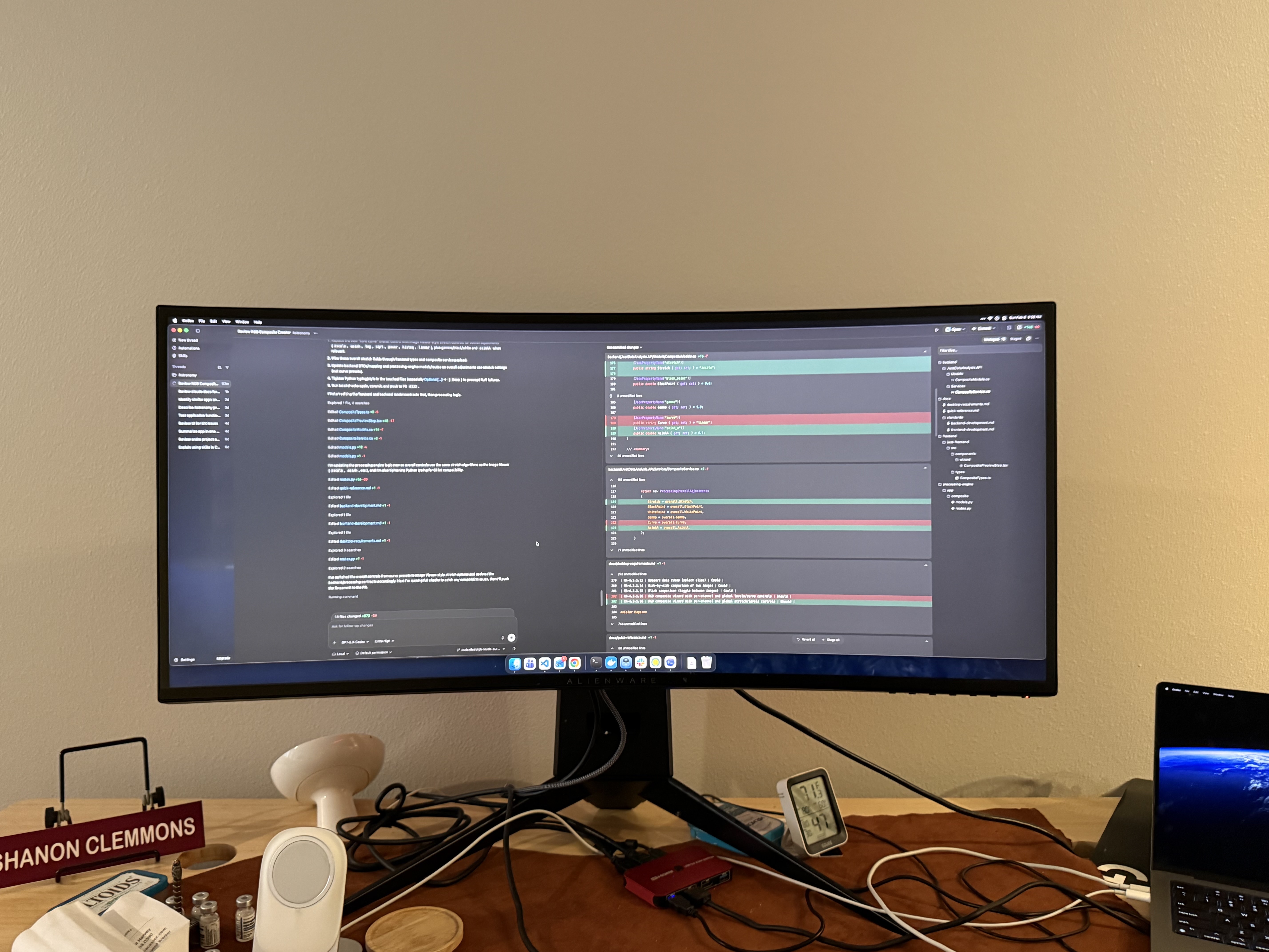 Ultrawide monitor workstation setup showing the application and code review side by side