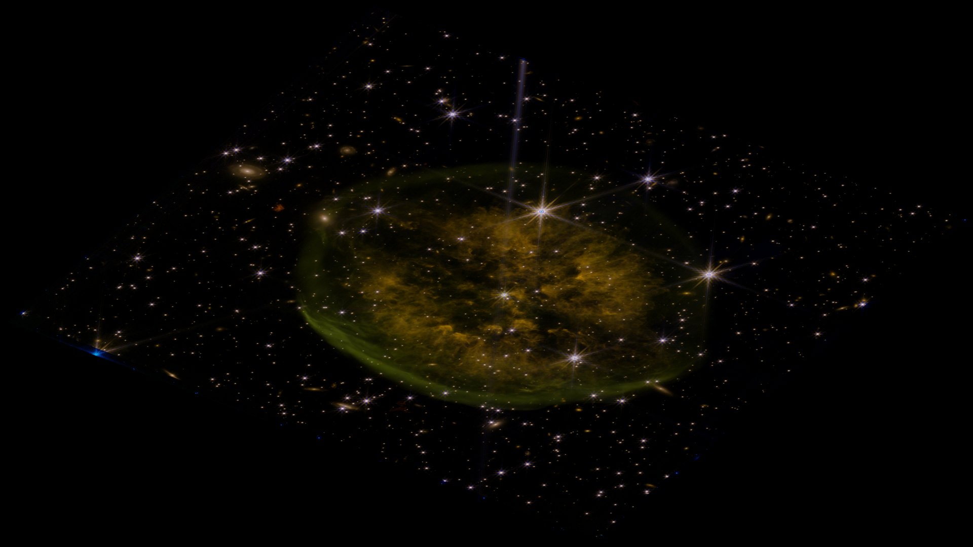 Second composite attempt using NIRCam data -- golden and orange tones with scattered stars, a very different look from the MIRI version